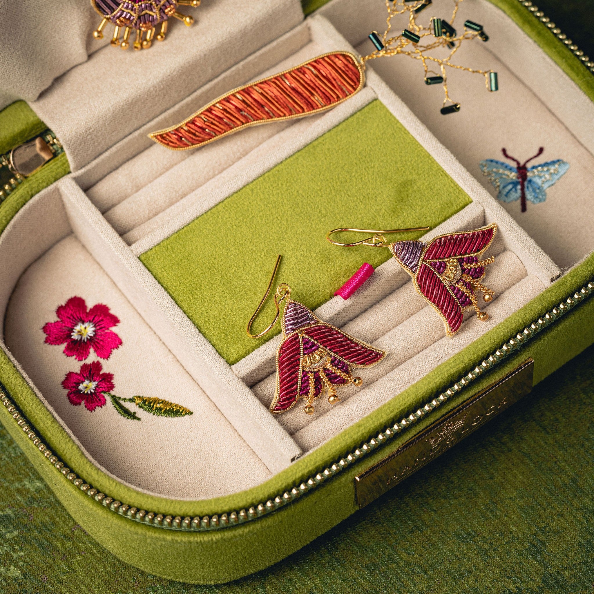 Fuchsia Earrings - Hand Embroidered flower earrings displayed on a green and cream jewellery box