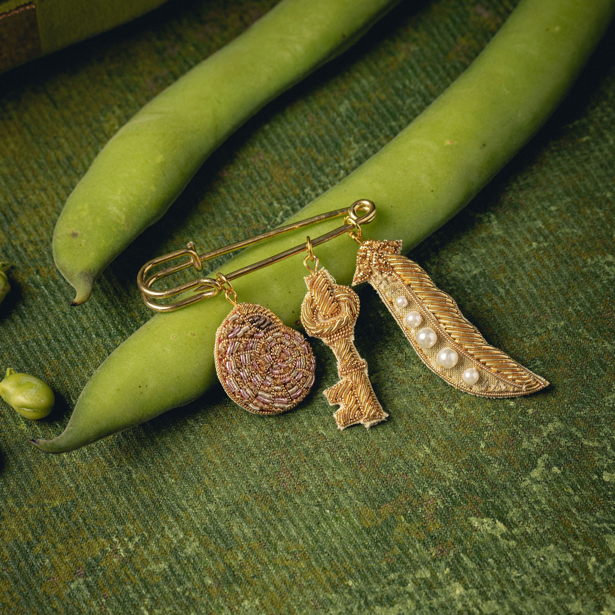 Garden Charm Brooch - Hand Embroidered charm brooch photographed on runner beans