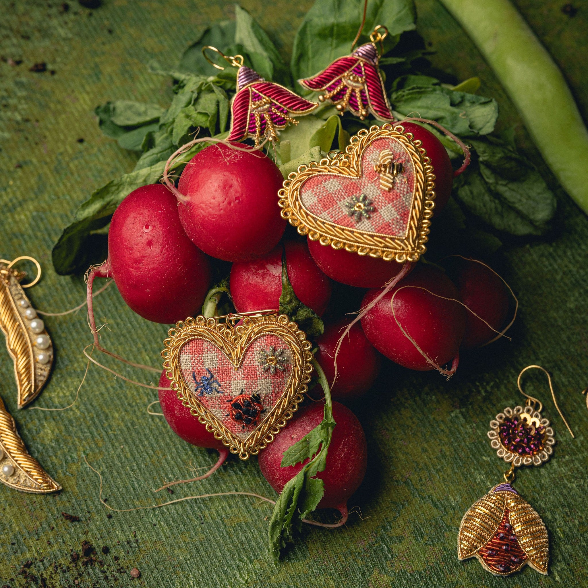 Picnic Heart Earrings - Hand Embroidered heart earrings with a gingham fabric displayed on radishes