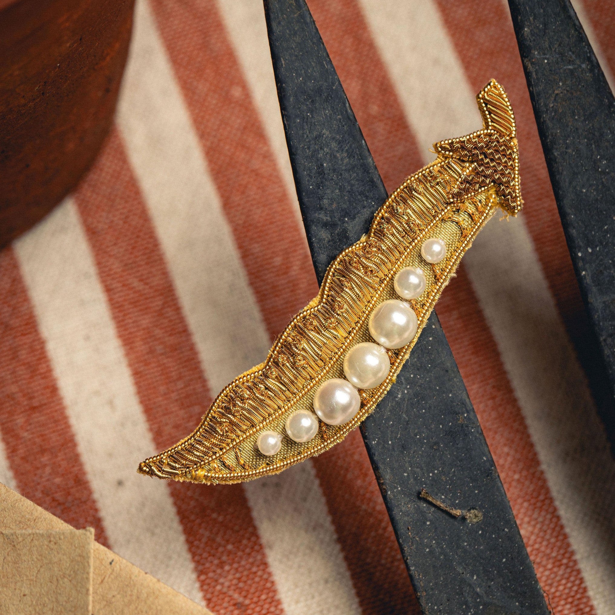 Golden Pea Brooch - Hand Embroidered brooch photographed on a striped background