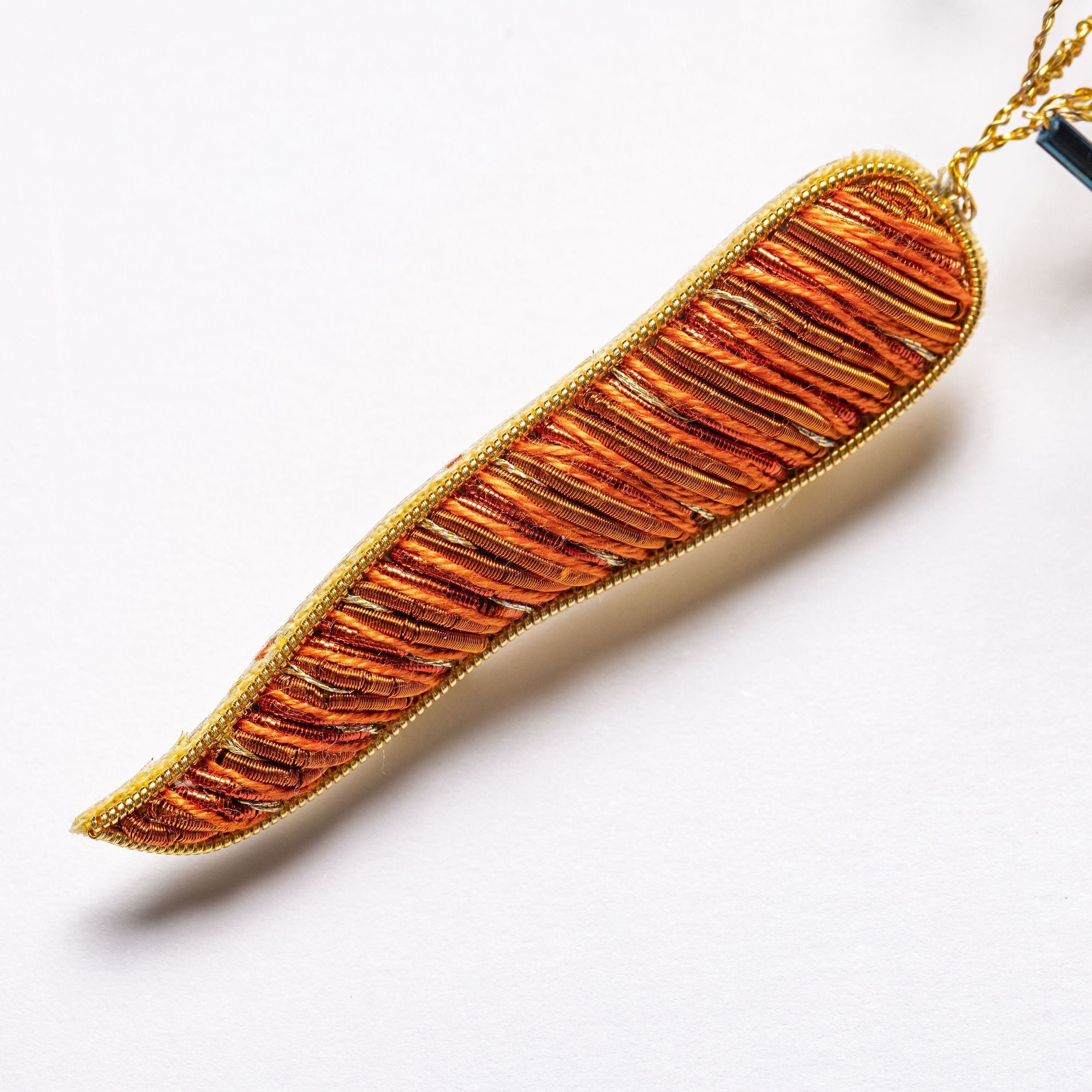 Carrot Brooch - Hand Embroidered carrot close up on a white background 