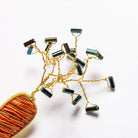 Carrot Brooch - Hand Embroidered carrot brooch close up of wire and bead leaves on a white background