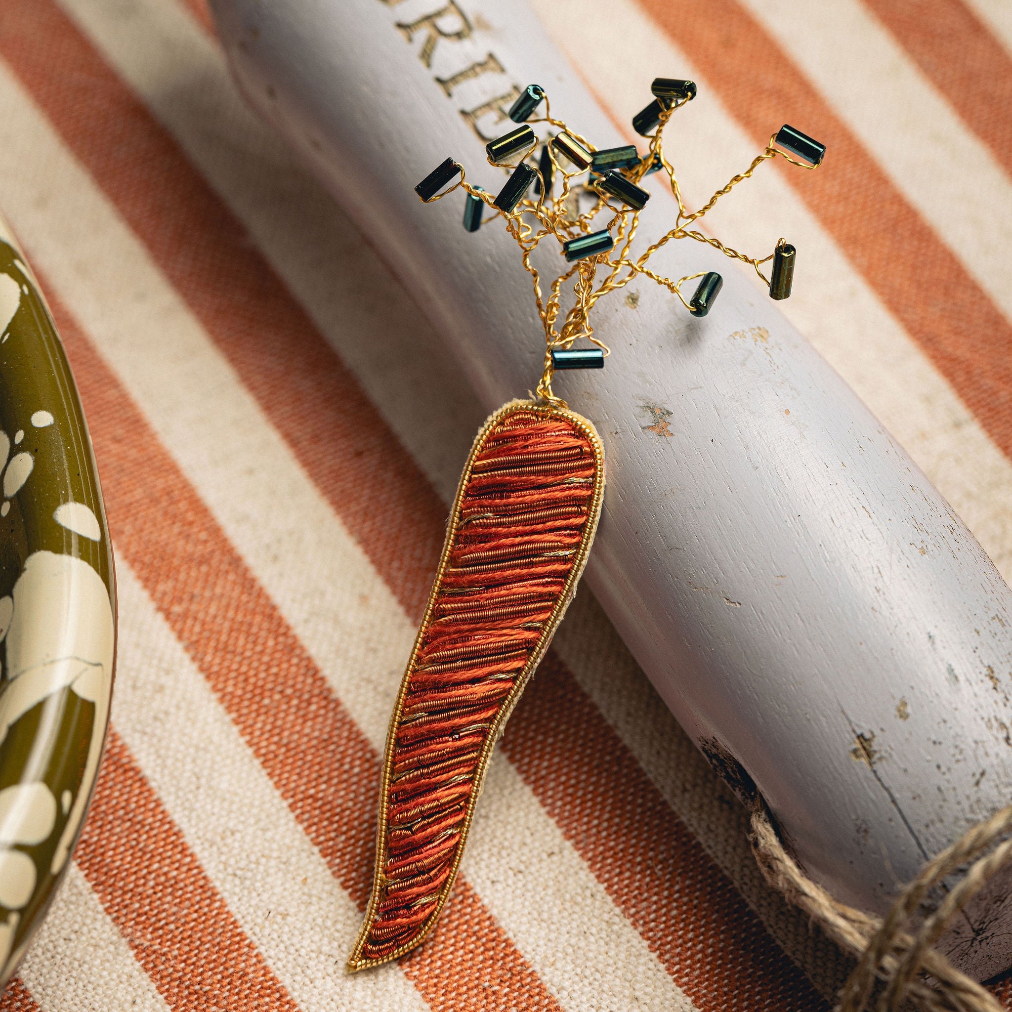 Carrot Brooch - Hand Embroidered carrot brooch on a striped background