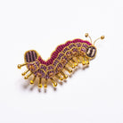 Colette the Caterpillar Brooch - Caterpillar embroidered brooch on a white background 