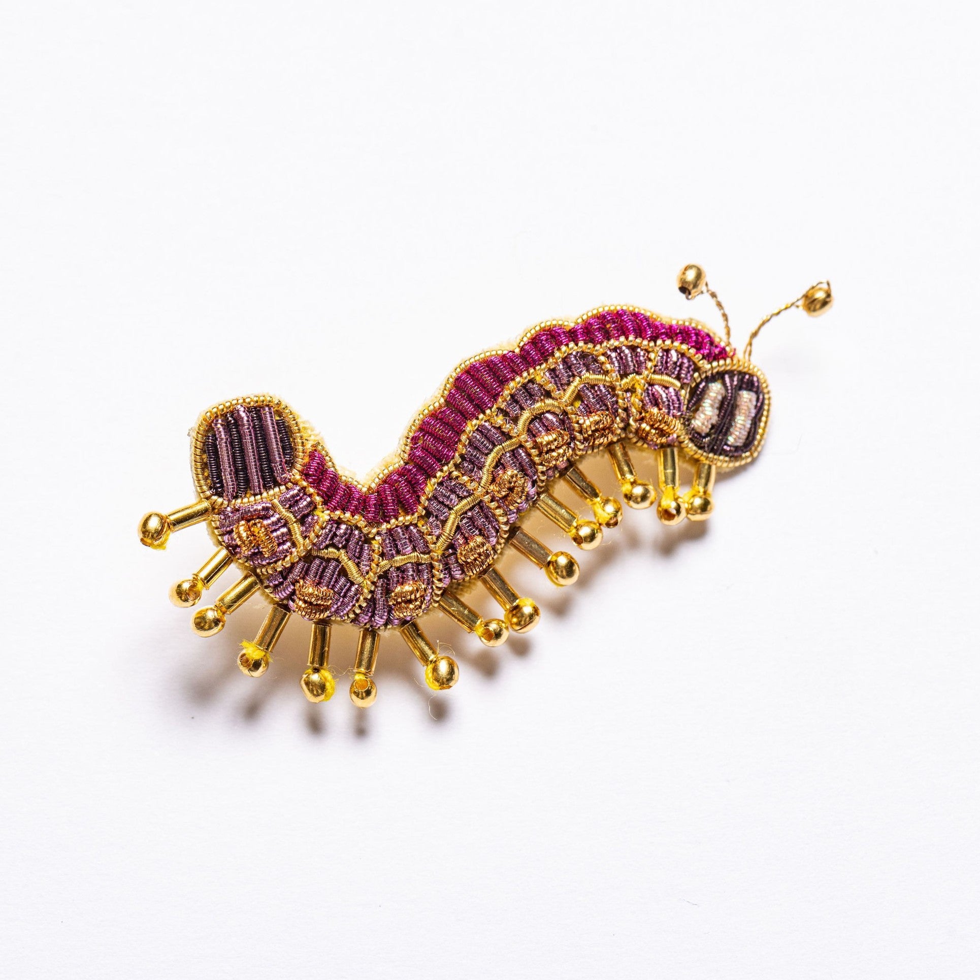 Colette the Caterpillar Brooch - Caterpillar embroidered brooch on a white background 