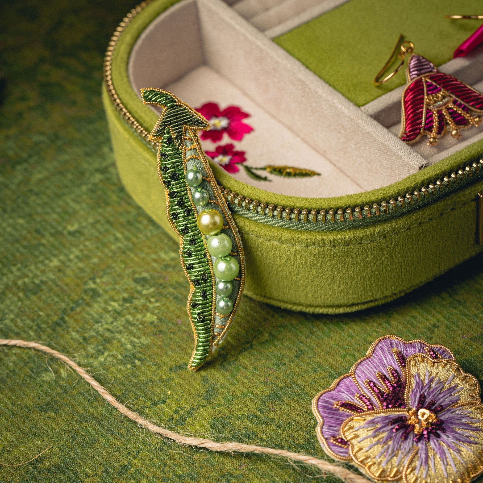 Green Pea Brooch - Hand Embroidered brooch with a green jewellery box on a green background