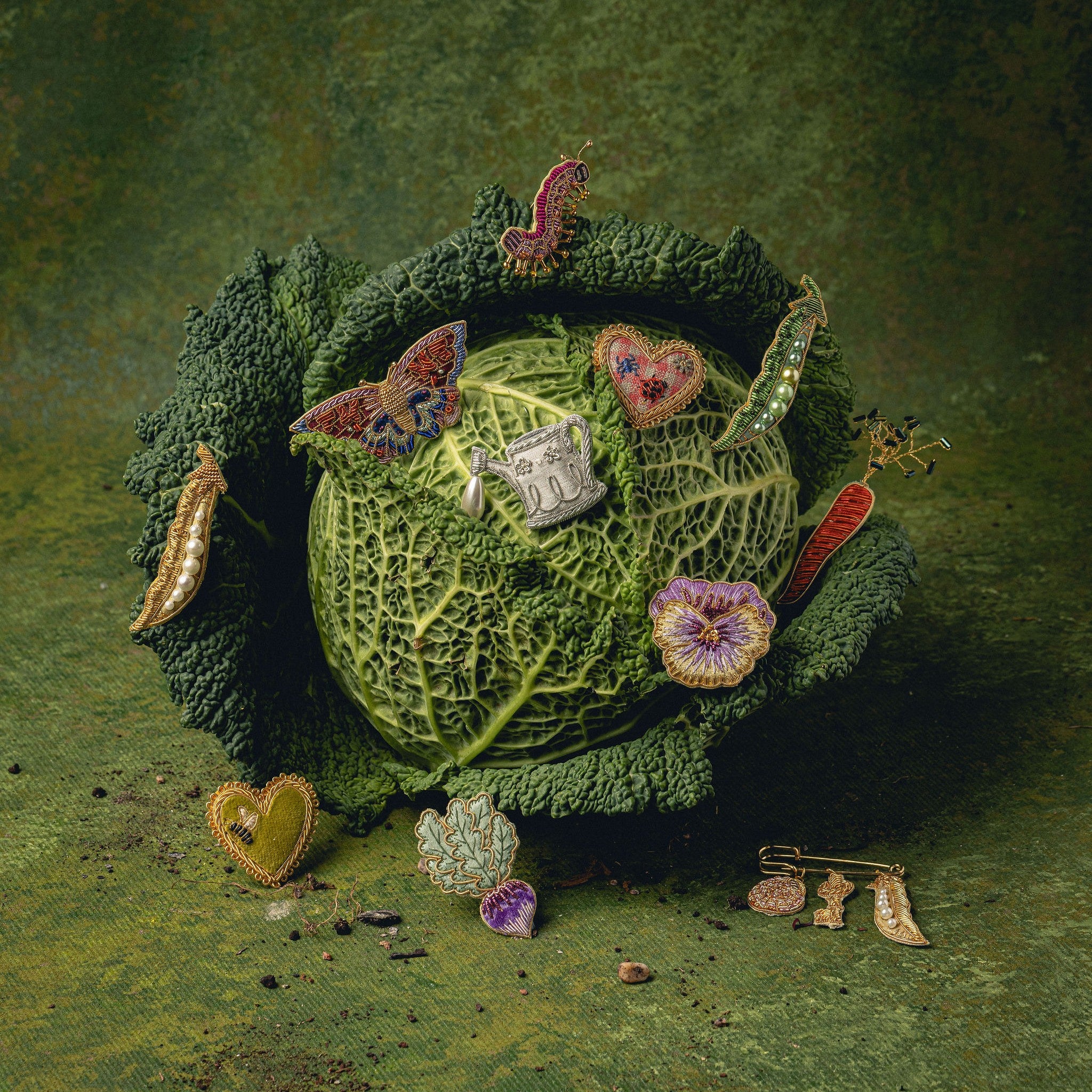 How Does Your Garden Grow? Collection of Hand Embroidered Jewellery - Decorative brooches on a green cabbage with green background