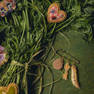 How Does Your Garden Grow? Collection of Hand Embroidered Jewellery - Hand embroidered brooches photographed on leaves and green background