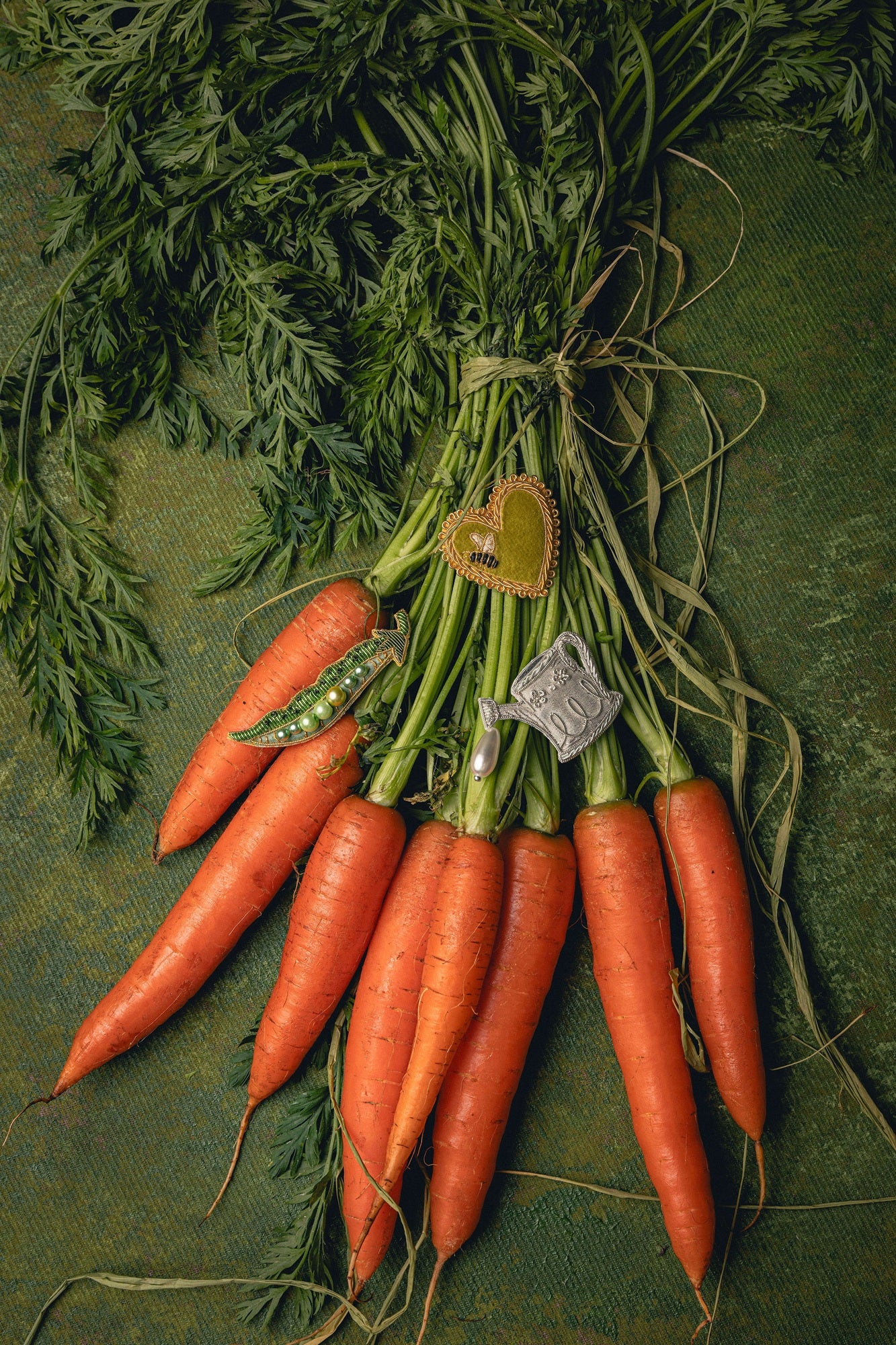 How Does Your Garden Grow? Collection of Hand Embroidered Jewellery - Bunch of carrots with brooches displayed on top