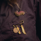 How Does Your Garden Grow? Collection of Hand Embroidered Jewellery - Decorative brooches displayed on a purple shirt