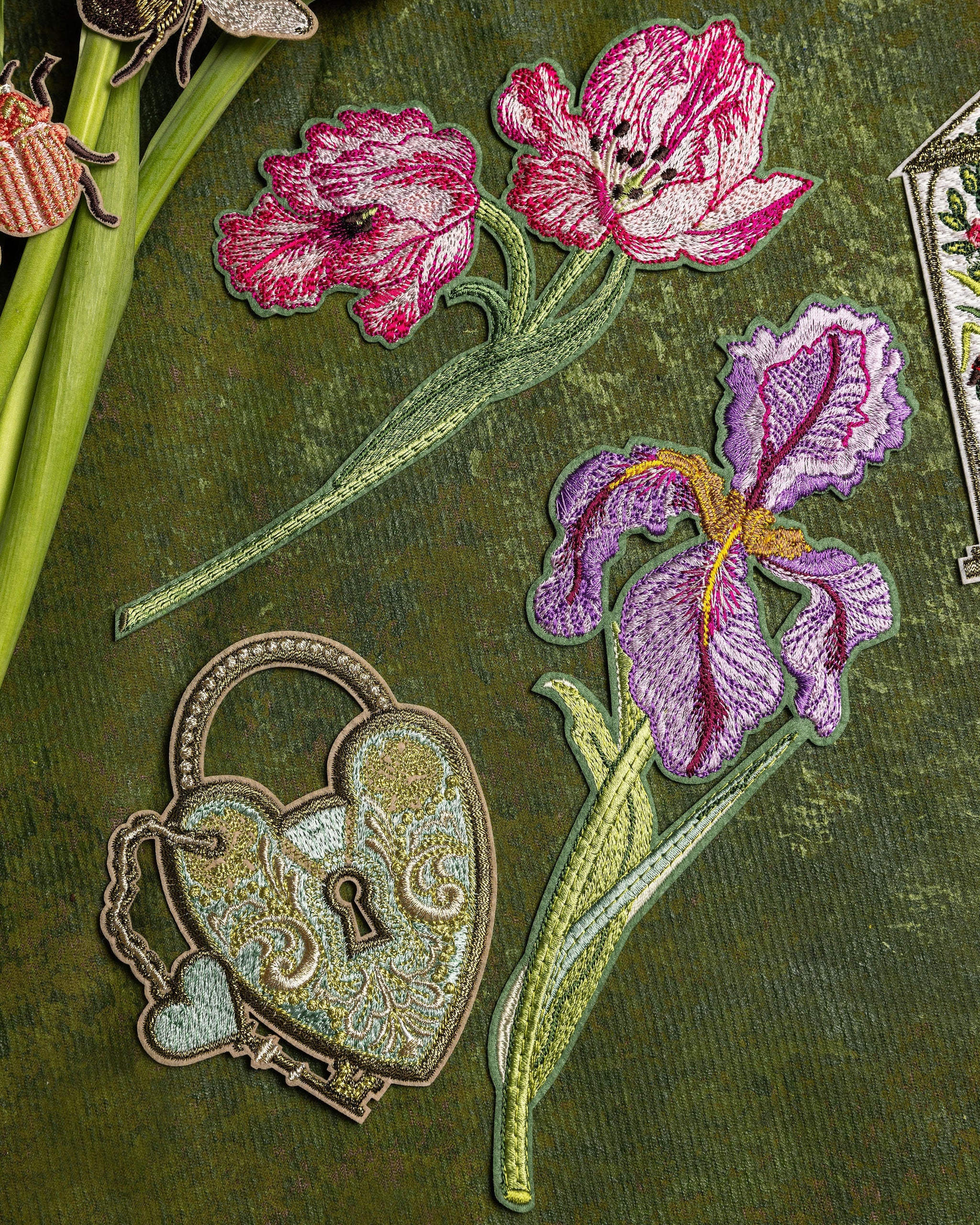 How Does our Garden Grow Collection - Embroidered patches of pink flowers and a heart-shaped lock on a green background