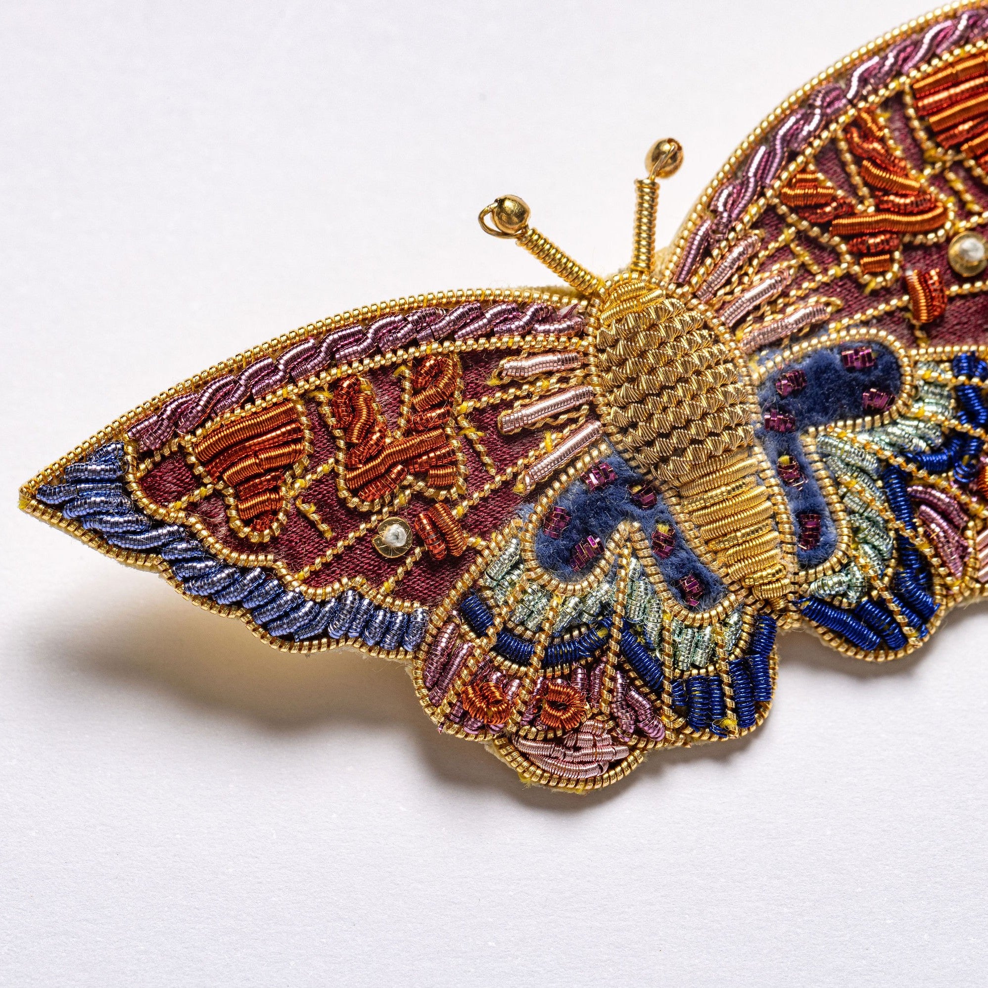 Kaleidoscope Butterfly Brooch - Hand Embroidered butterfly brooch close up on a white background 