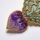 Radish Brooch - Close up of the hand embroidery details, shown on a white background 