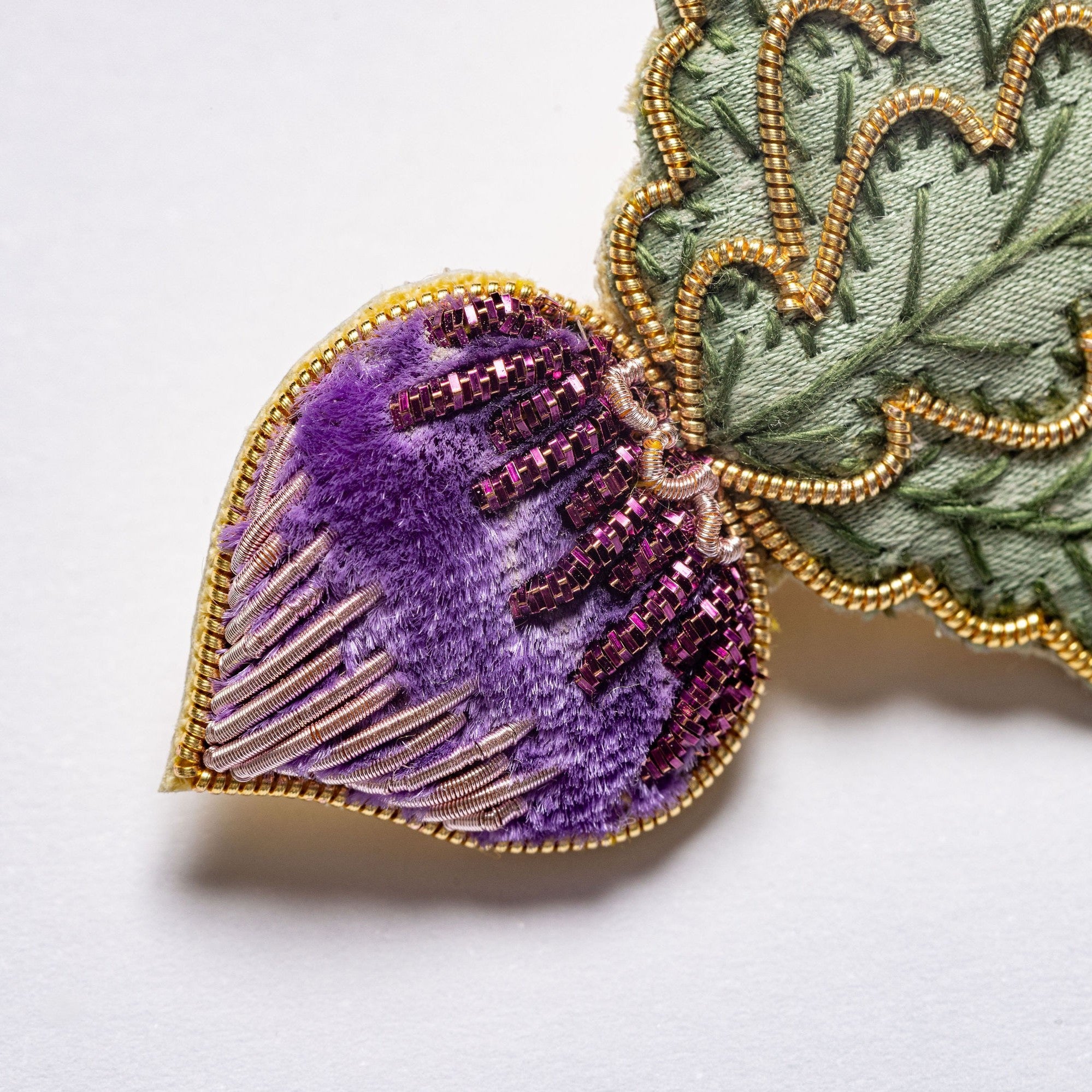 Radish Brooch - Close up of the hand embroidery details, shown on a white background 