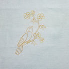 The Bird & Blossoms Kit - Decorative design of a bird and flowers printed on a light blue fabric background. Base for an embroidery design