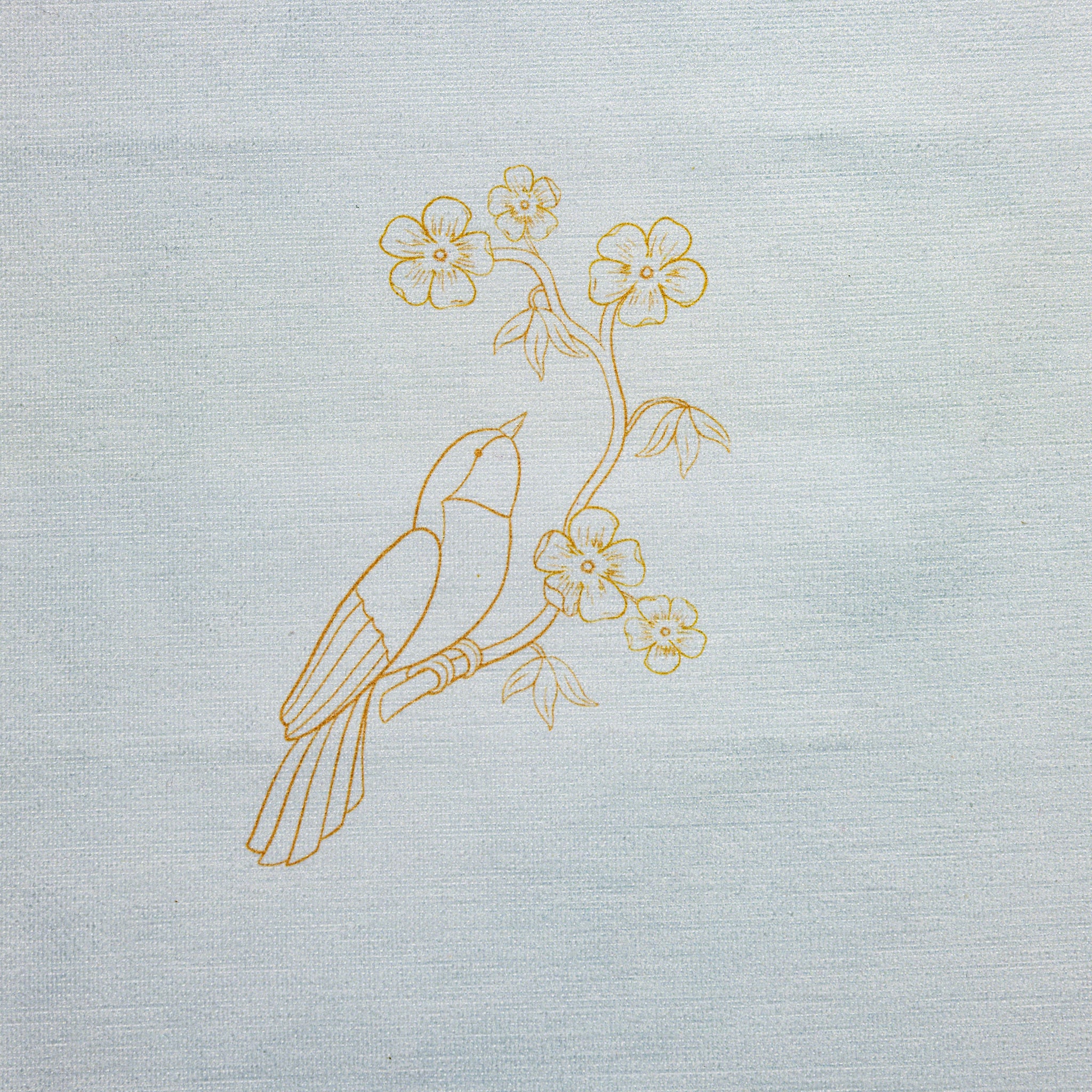 The Bird & Blossoms Kit - Decorative design of a bird and flowers printed on a light blue fabric background. Base for an embroidery design