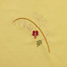 The Bleeding Heart Kit - Yellow fabric with a printed floral design, partially hand embroidered work in progress