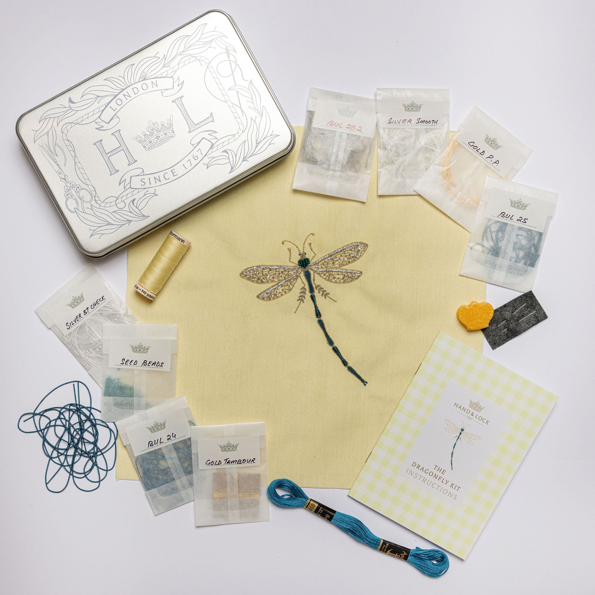 The Dragonfly Kit - Dragonfly design embroidery kit with materials on a white background