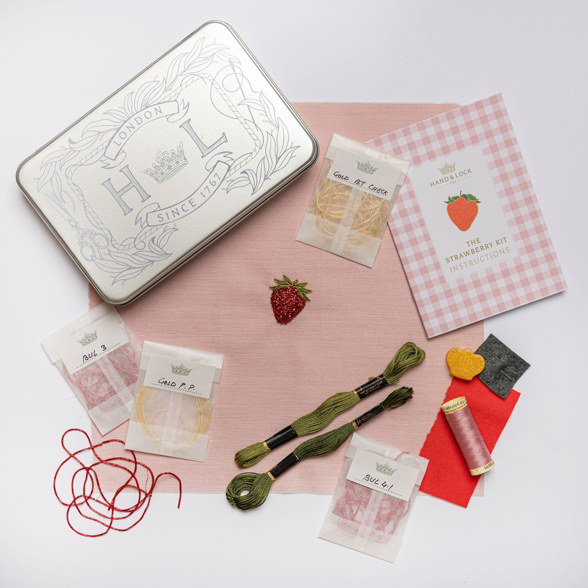 The Strawberry Kit - Strawberry embroidery kit with materials on a white background