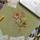 The Wild Bouquet Kit - Embroidered flowers on green fabric