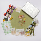 The Wild Bouquet Kit - Floral embroidery kit with materials and a completed floral design on fabric.